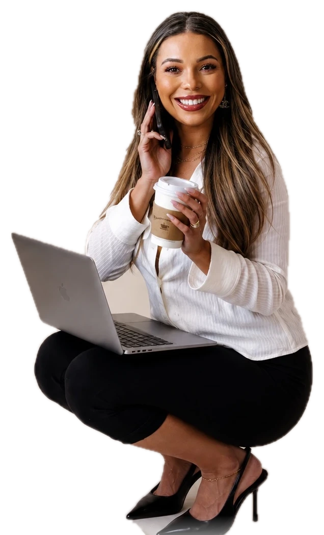 Jenica crouching with her laptop and coffee during a JOAT brand portrait