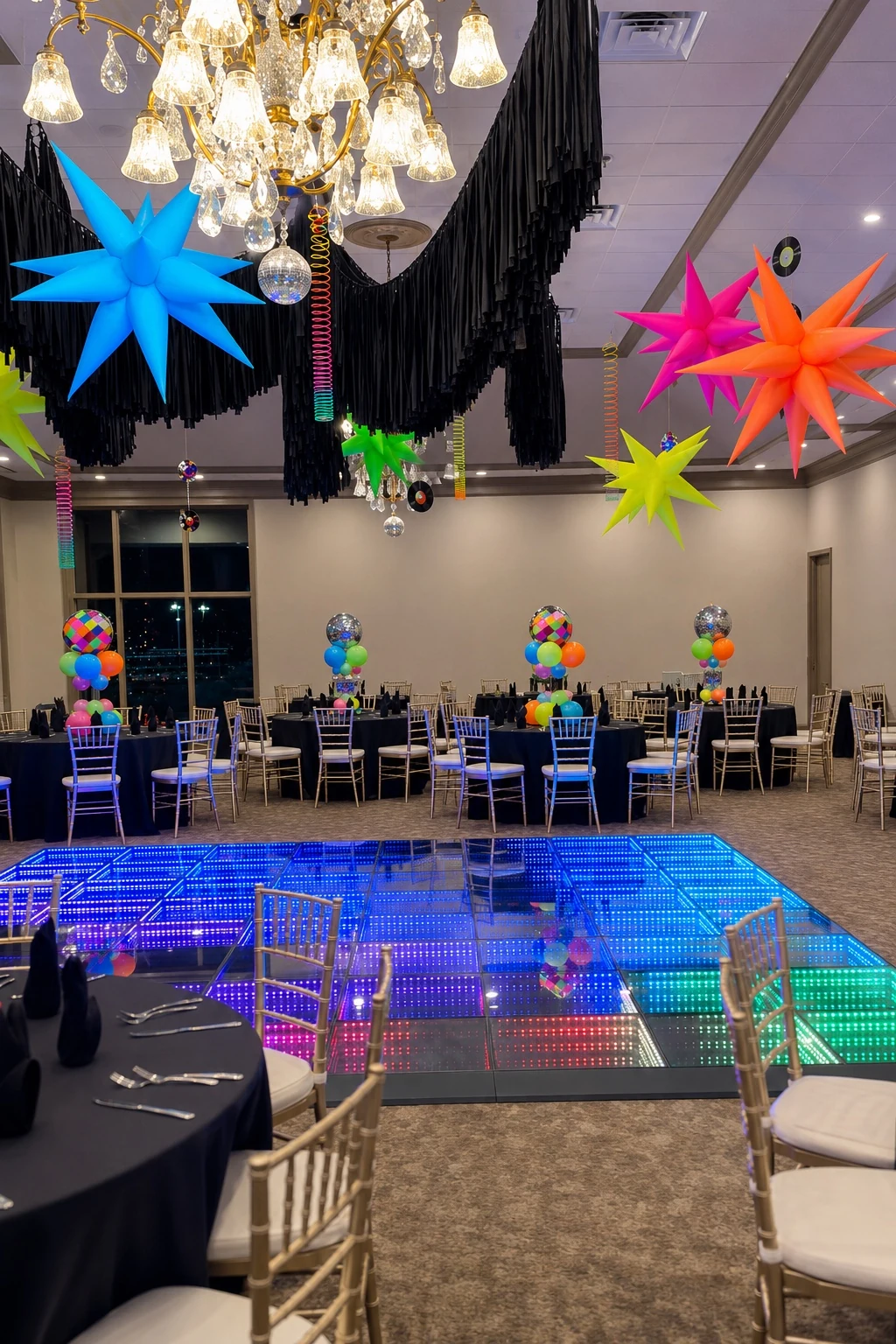 Wide ballroom view with centerpieces and dance floor