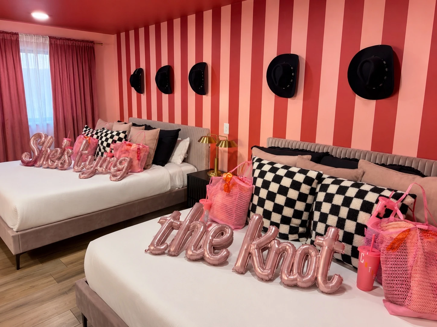 Bachelorette bedroom arrival styling with custom bags, pillows, and coordinated décor
