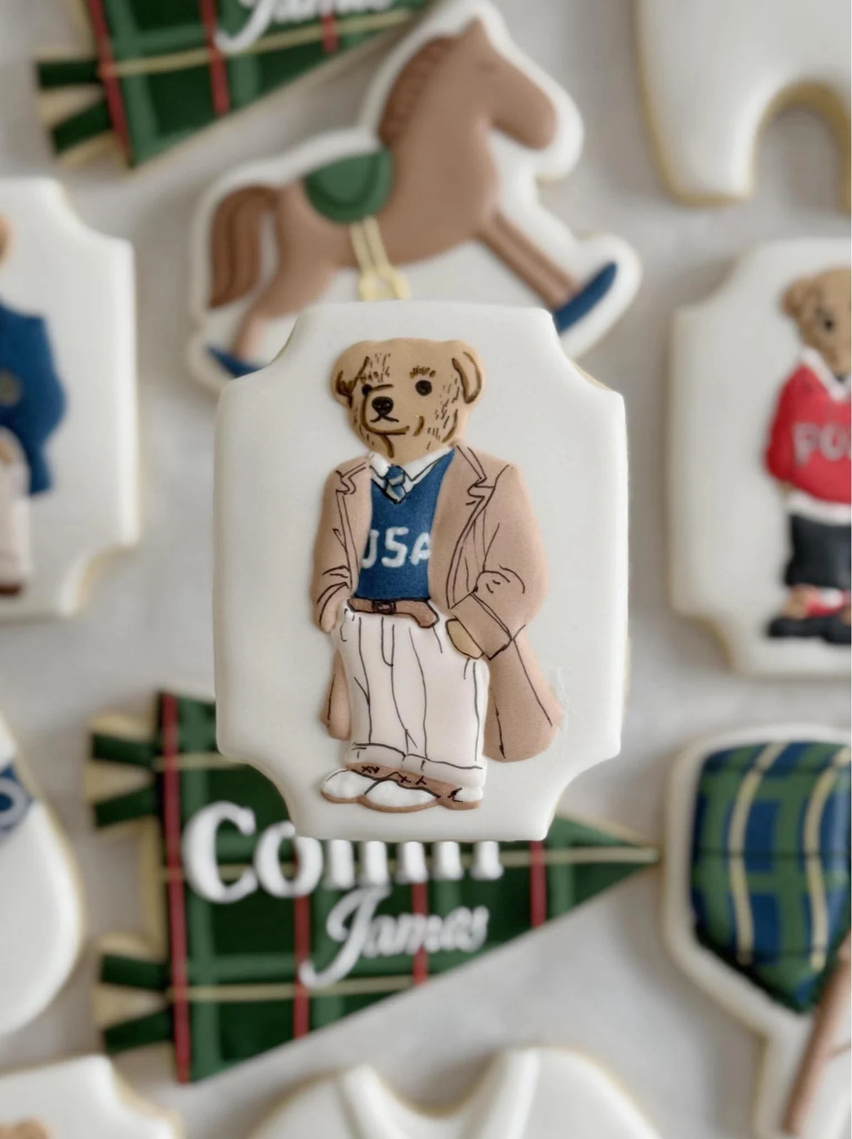 Close-up of a custom teddy-bear cookie in a blue sweater