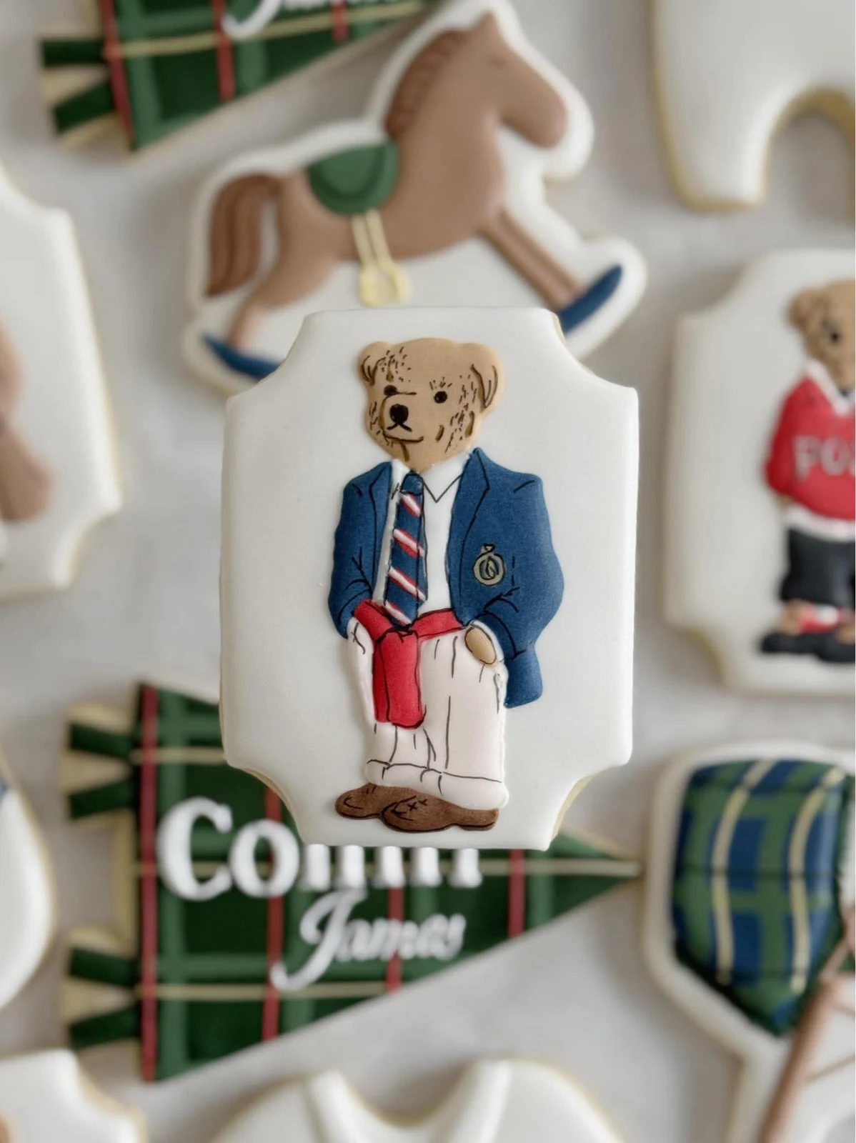 Close-up of a custom teddy-bear cookie dressed in a navy blazer