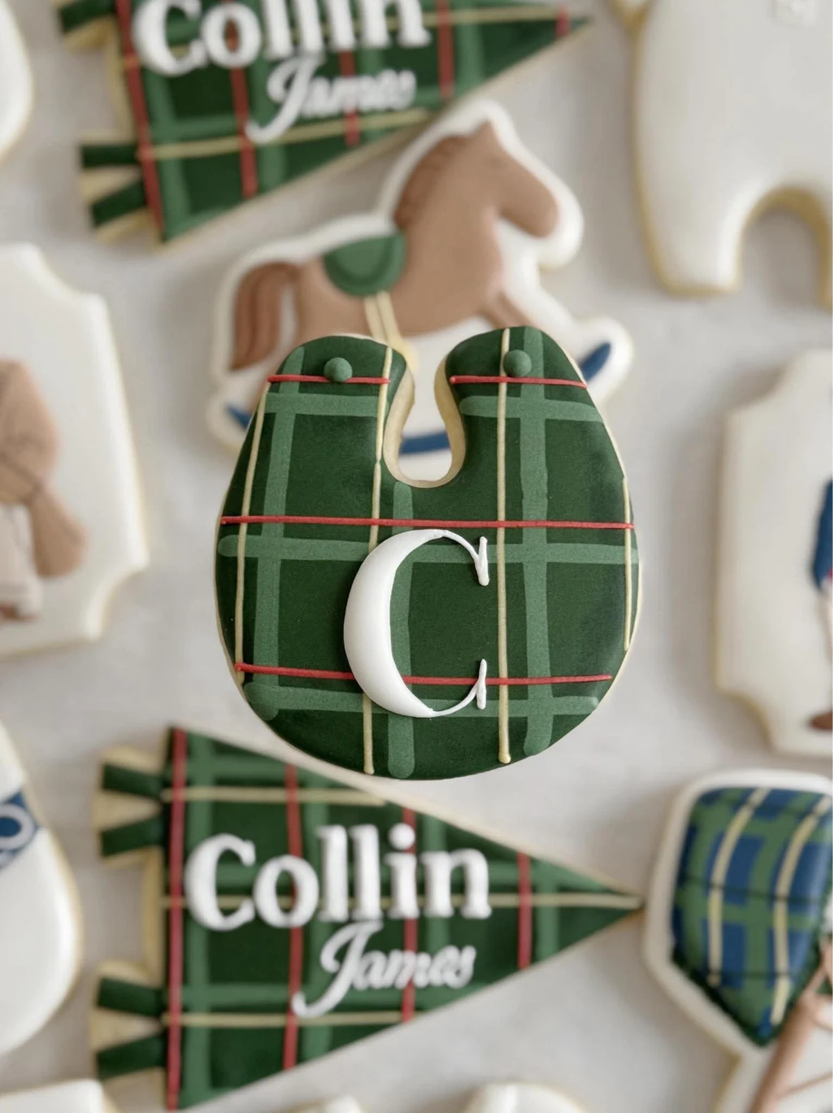 Close-up of a green plaid monogram cookie for Collin James