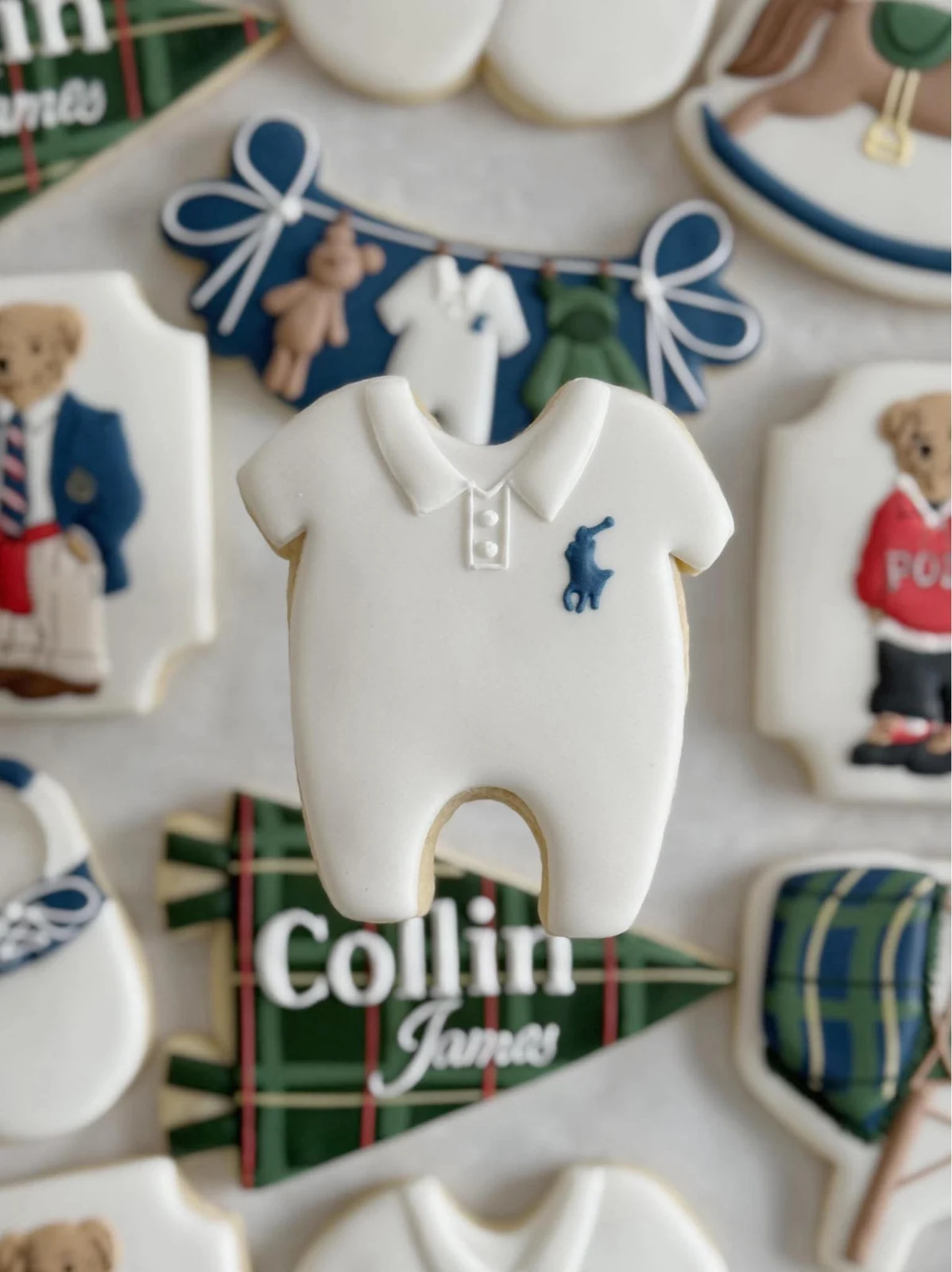 Close-up of a white baby-onesie cookie with blue detailing