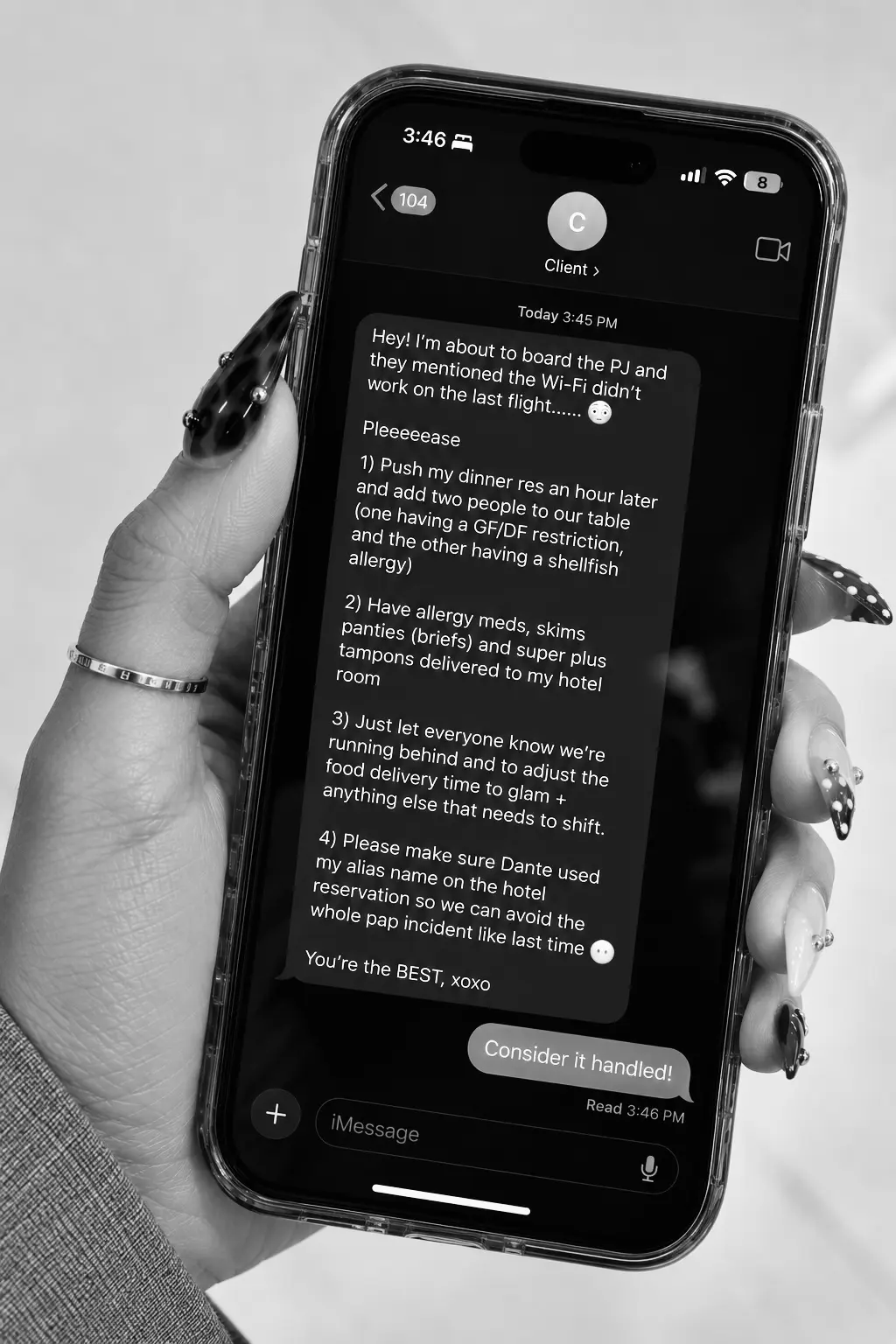 A hand holding a phone showing a client text with four requests, answered with "Consider it handled!"