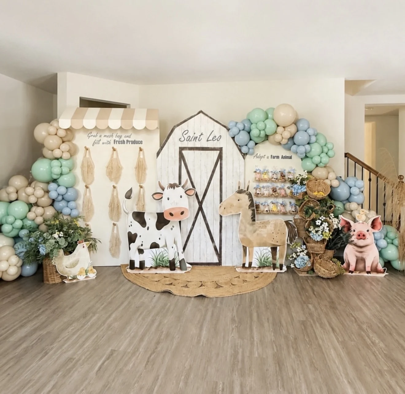 Saint's farm-themed birthday backdrop with activity stations, balloons, flowers, and farm animals