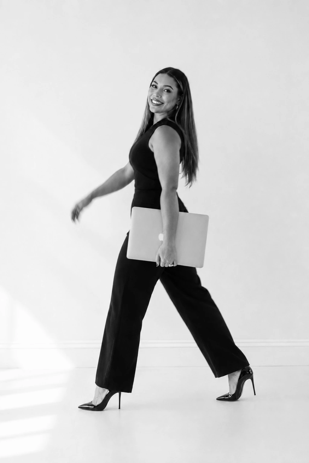 Jenica walking with a laptop in a second editorial frame