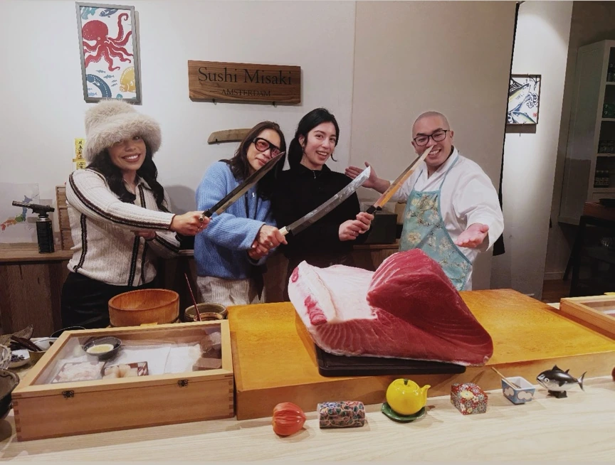 Jenica and guests with the chef and a whole tuna at Sushi Misaki in Amsterdam