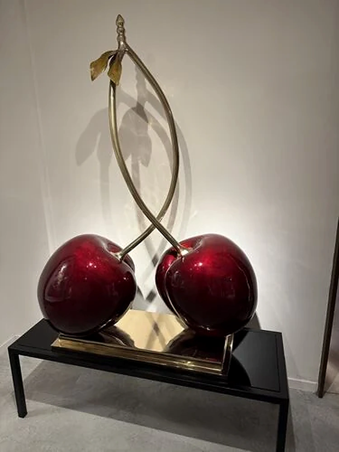 A sculptural cherry artwork in a gallery