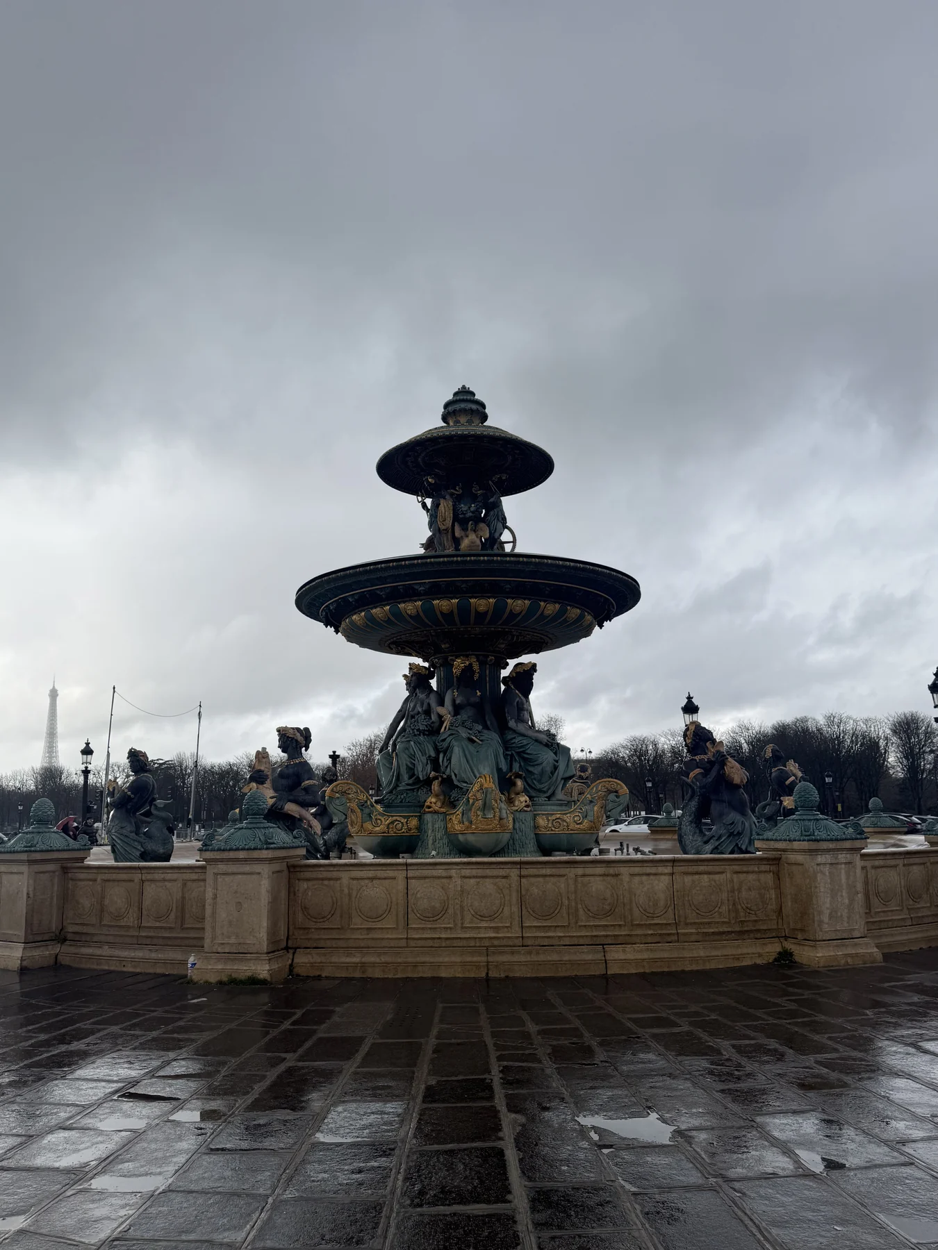 A fountain in Paris on a rainy day