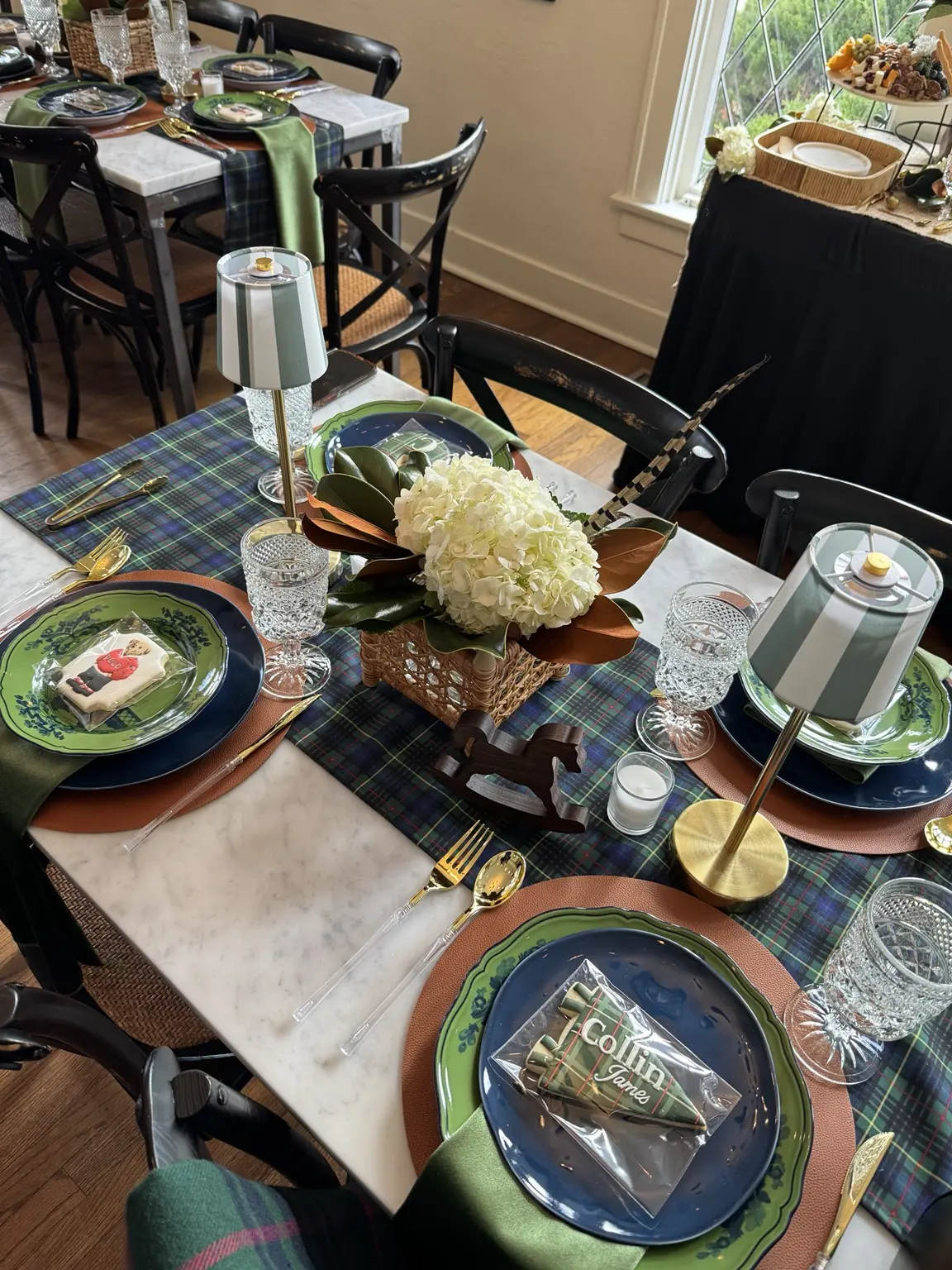 A green tartan baby shower table with custom Collin James cookies