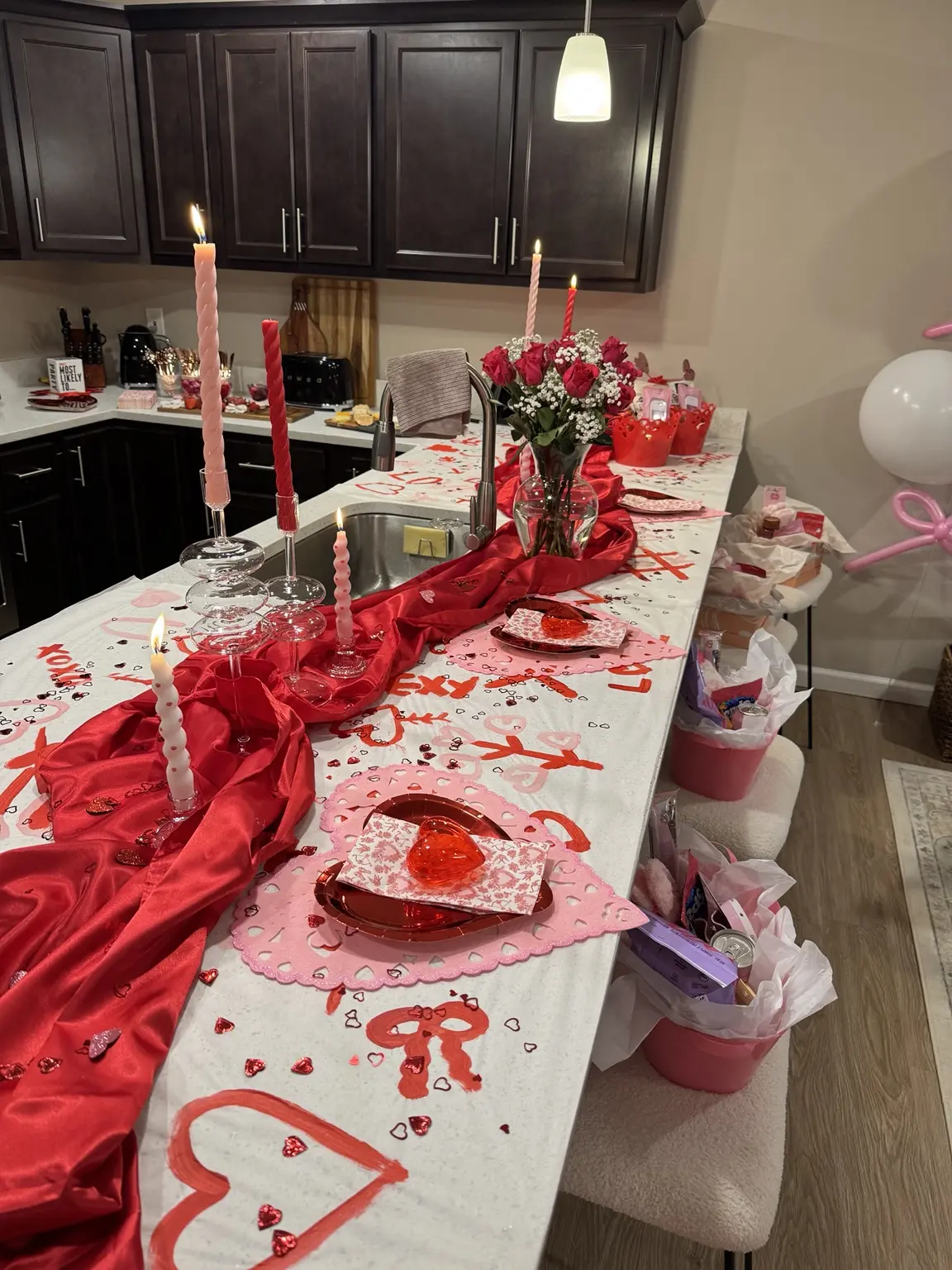 Galentine’s table with red satin, pink candles, flowers, and place settings