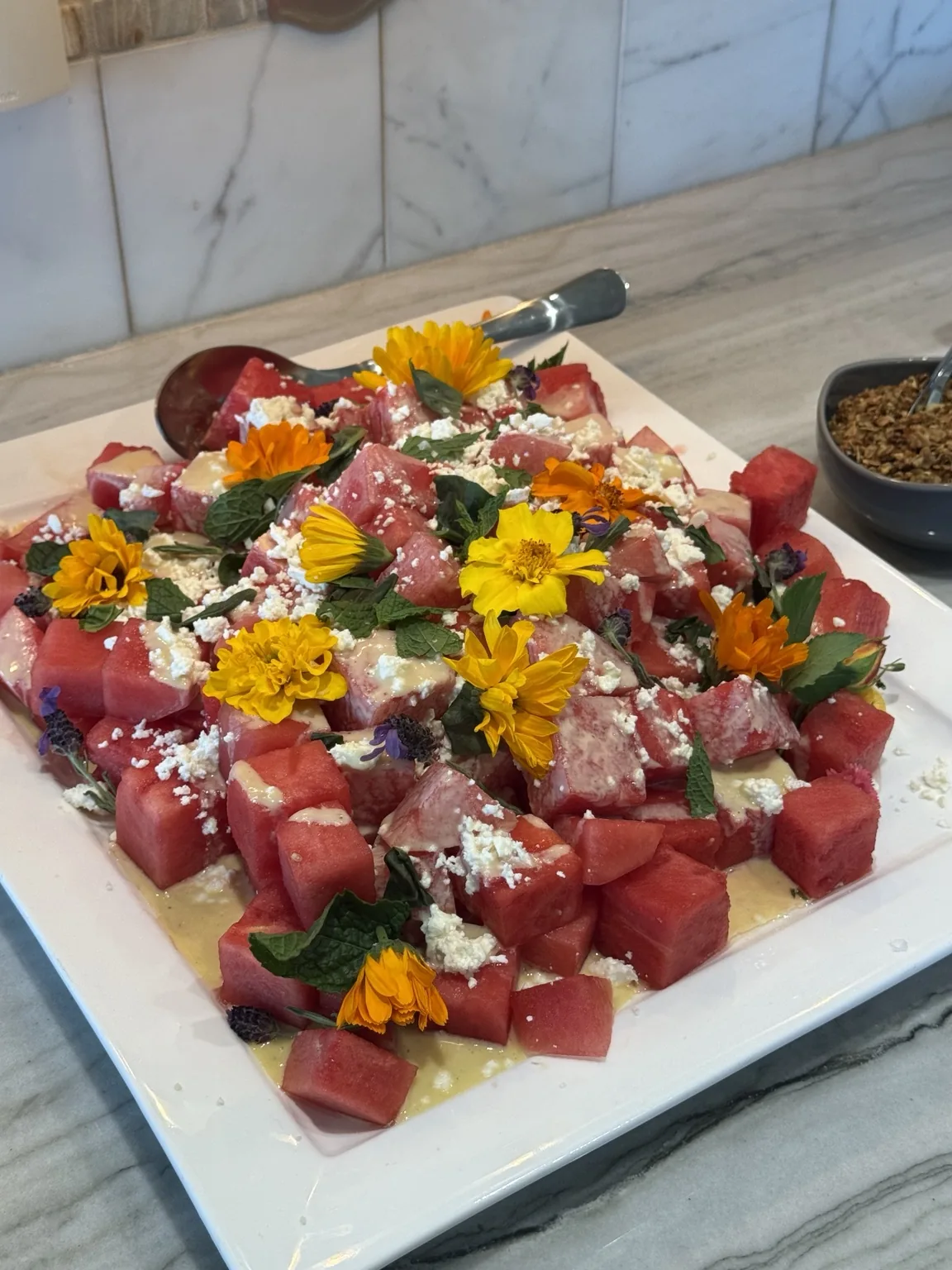 Watermelon salad with feta and edible flowers